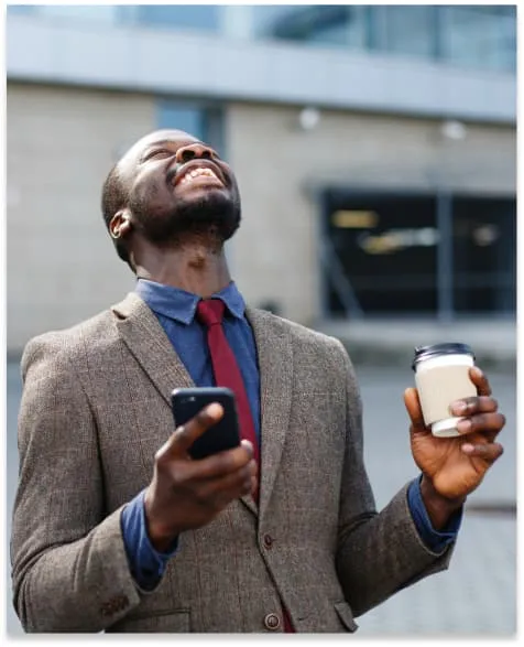 happy african american man looks lucky reading something his smartphone