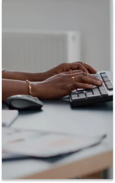 closeup teenager with dark skin hands keyboard typing email computer working education